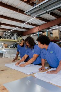 Diamond Air Design team members looking over a plan