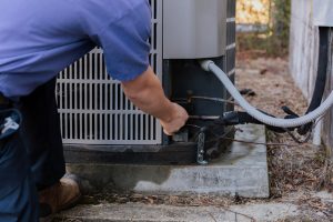 Diamond Air Design team member fixing an AC unit